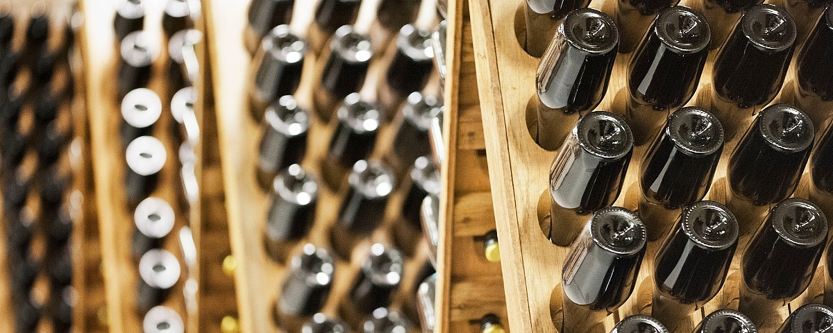 Deutscher Sekttag  Sparkling wine bottles in traditional vats for bottle fermentation, stored at an angle and lined up for ageing.